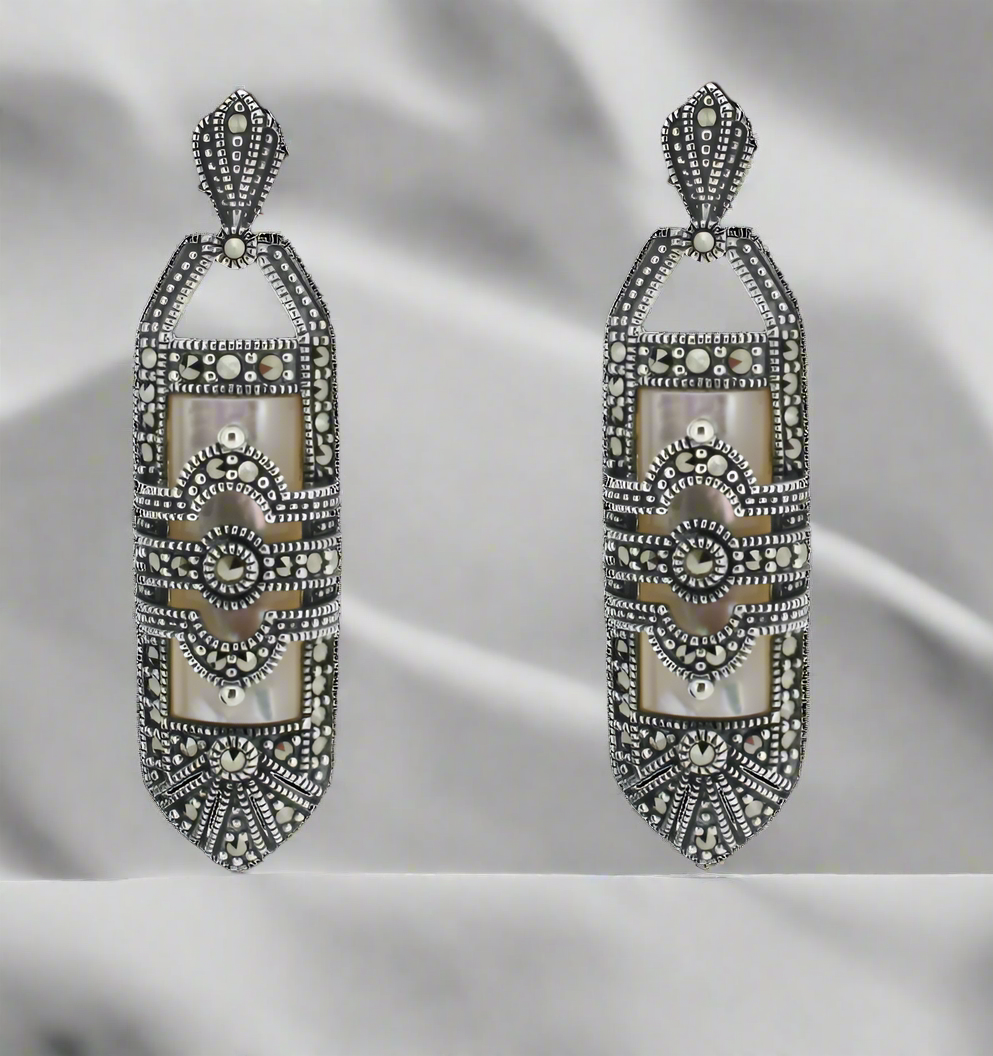 Decorative earrings with intricate designs on a white background