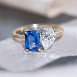 Toi et Moi ring with an emerald cut sapphire and a lab grown pear cut diamond