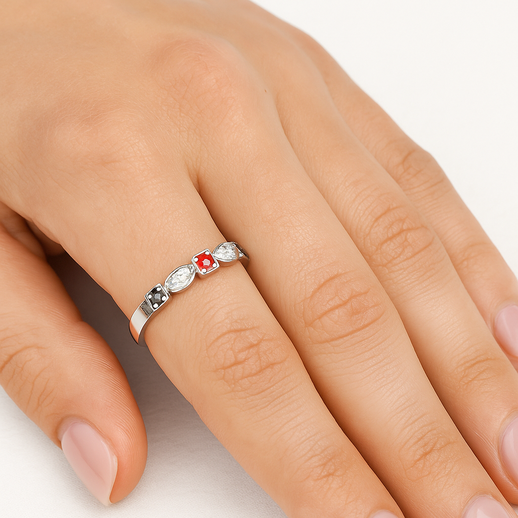 Three Birthstone ring in white gold on index finger of hand