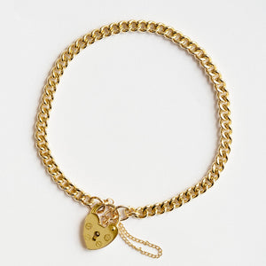 Gold curb link bracelet with padlock