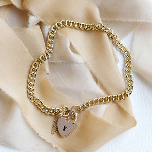 Curb link bracelet with heart shaped lock