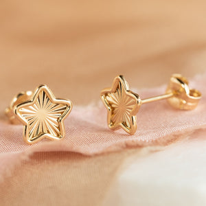 Gold star shaped stud earrings