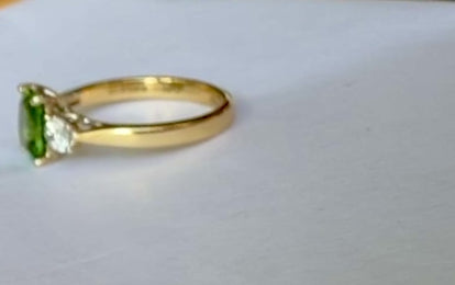 A video of a green tourmaline and diamond ring turning around
