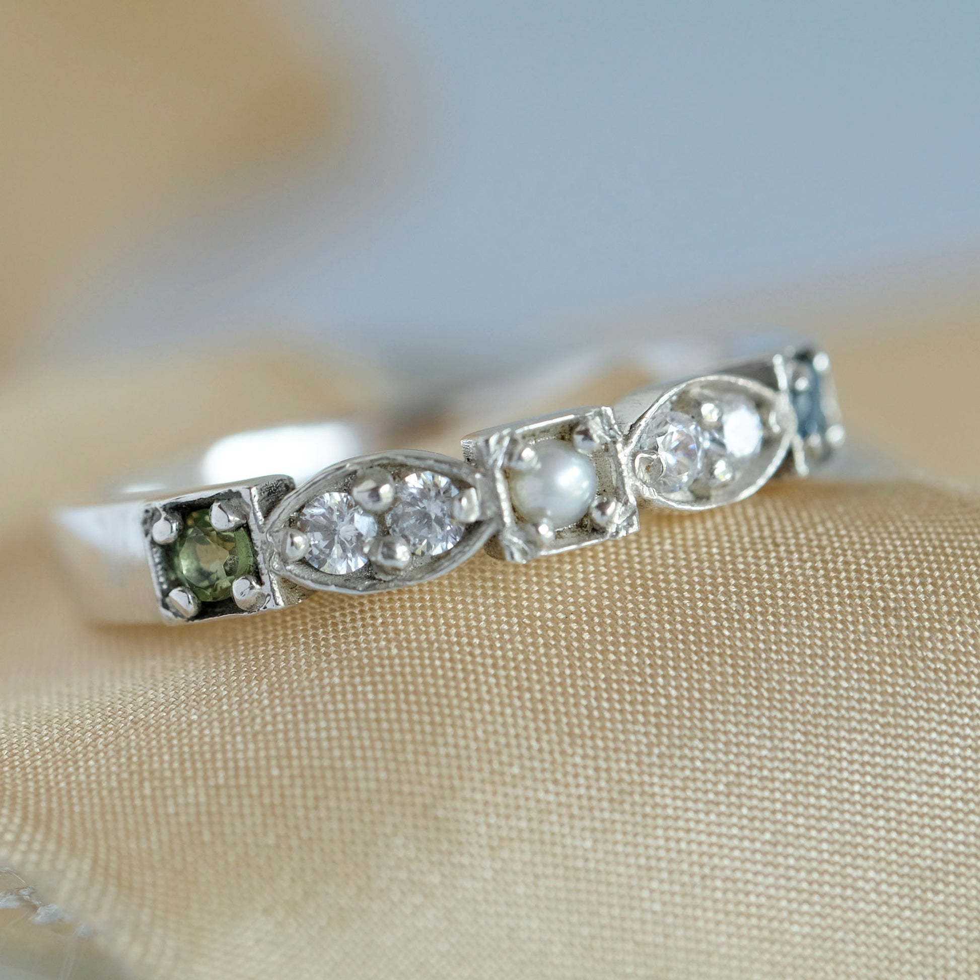 An heirloom ring with diamonds and three birthstones