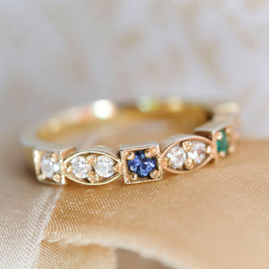 4 birthstone yellow gold heirloom ring showing diamonds and sapphire