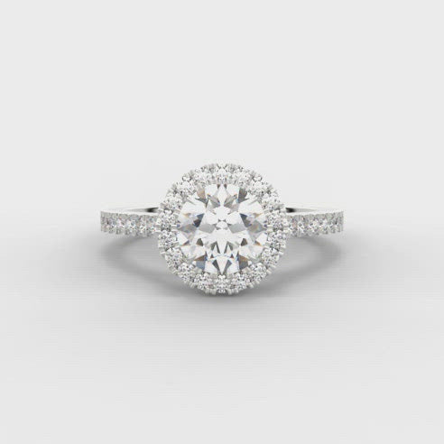 0.75ct Round Brilliant Cut Diamond Engagement ring with Halo surround and Diamond Set Shoulders  Centre Diamond Weight: 0.75ct  Centre Stone Cut: Round Brilliant  Diamond Weight on Halo/Shoulders: 0.35ct  Diamond Cut on Shoulders: Round Brilliant  Total Diamond Weight: 1.10ct  Note:  This ring is made to order and lead time is 6 weeks.