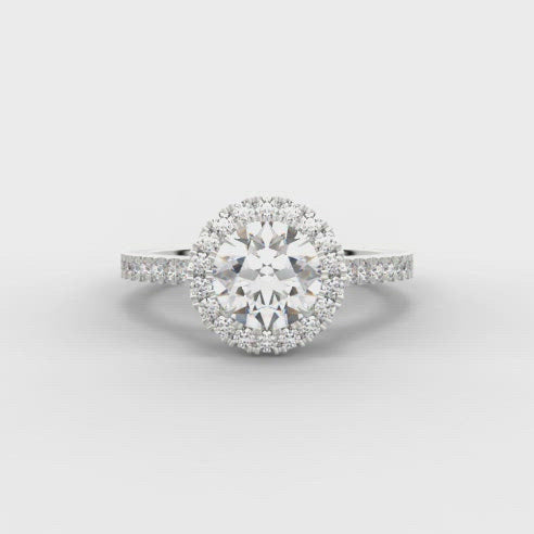 0.75ct Round Brilliant Cut Diamond Engagement ring with Halo surround and Diamond Set Shoulders  Centre Diamond Weight: 0.75ct  Centre Stone Cut: Round Brilliant  Diamond Weight on Halo/Shoulders: 0.35ct  Diamond Cut on Shoulders: Round Brilliant  Total Diamond Weight: 1.10ct  Note:  This ring is made to order and lead time is 6 weeks.