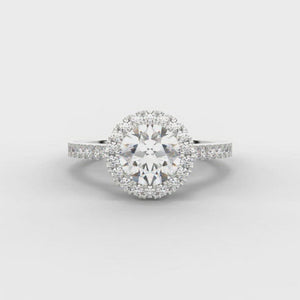 0.75ct Round Brilliant Cut Diamond Engagement ring with Halo surround and Diamond Set Shoulders  Centre Diamond Weight: 0.75ct  Centre Stone Cut: Round Brilliant  Diamond Weight on Halo/Shoulders: 0.35ct  Diamond Cut on Shoulders: Round Brilliant  Total Diamond Weight: 1.10ct  Note:  This ring is made to order and lead time is 6 weeks.