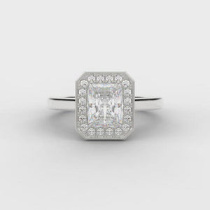 0.50ct Emerald Cut Diamond Engagement ring with a diamond halo surround and plain shoulders.  Centre Diamond Weight: 0.50ct  Centre Stone Cut: Emerald Cut  Diamond Weight on Halo: 0.15ct  Diamond Cut on Halo: Round Brilliant Cut  Total Diamond Weight: 0.65ct  Available in Yellow Gold, Rose Gold, White Gold and Platinum.  This ring is also available with Lab Grown Diamonds - contact us for further information.