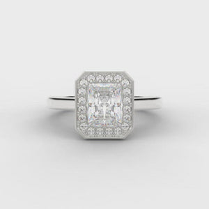 0.33ct Emerald Cut Diamond in a Diamond Halo Setting with Plain Shoulders   Centre Diamond Weight: 0.33ct  Centre Stone Cut: Emerald Cut  Diamond Weight on Halo: 0.10ct  Diamond Cut on Halo: Round Brilliant Cut  Total Diamond Weight: 0.43ct   Available in Yellow Gold, Rose Gold, White Gold and Platinum.