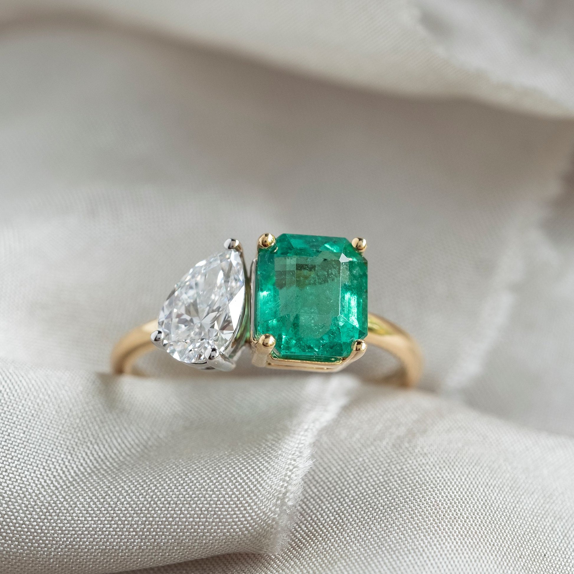 The toi et moi ring meaning “you and me” is one of the most historic ring setting styles that symbolizes love stories and partnerships.  This stunning ring has a Pear Cut Lab Grown Diamond - 0,8ct  Colour D  Clarity VS2  Sitting beside it is a 2.22ct Emerald   We have size N in stock