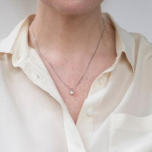 white gold diamond pendant shown on model