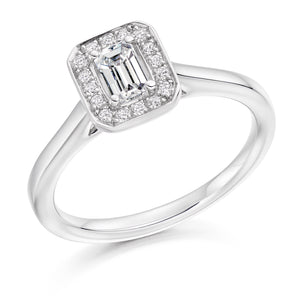 0.33ct Emerald Cut Diamond in a Diamond Halo Setting with Plain Shoulders   Centre Diamond Weight: 0.33ct  Centre Stone Cut: Emerald Cut  Diamond Weight on Halo: 0.10ct  Diamond Cut on Halo: Round Brilliant Cut  Total Diamond Weight: 0.43ct   Available in Yellow Gold, Rose Gold, White Gold and Platinum.