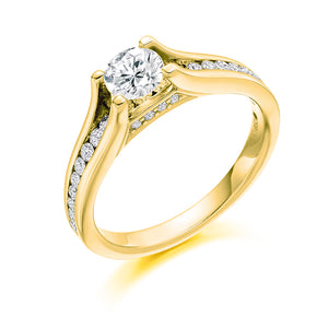 This Solitaire Engagement Ring has a 0.50ct Round Brilliant Cut centre diamond in a four claw setting.  It is beautifully accented by round brilliant cut diamonds both on the band and subtly under the main stone totalling 0.40ct  This gives total diamond weight of 0.90ct
