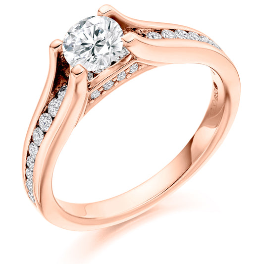 This Solitaire Engagement Ring has a 0.50ct Round Brilliant Cut centre diamond in a four claw setting.  It is beautifully accented by round brilliant cut diamonds both on the band and subtly under the main stone totalling 0.40ct  This gives total diamond weight of 0.90ct