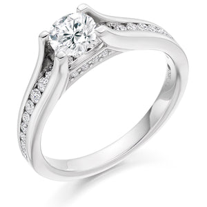 This Solitaire Engagement Ring has a 0.50ct Round Brilliant Cut centre diamond in a four claw setting.  It is beautifully accented by round brilliant cut diamonds both on the band and subtly under the main stone totalling 0.40ct  This gives total diamond weight of 0.90ct