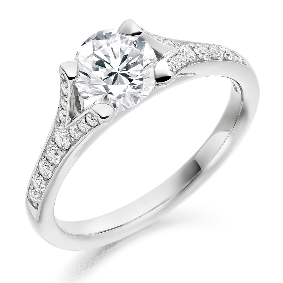 0.50ct Diamond Solitaire Engagement Ring with Split Diamond Set Shoulders  Centre Diamond Weight: 0.50ct  Centre Stone Cut: Round Brilliant  Diamond Weight on Shoulders: 0.20ct  Total Diamond Weight: 0.70ct