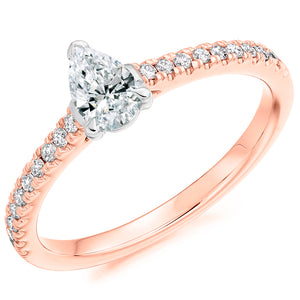 0.33ct Pear Cut Solitaire with Diamond Set Shoulders  This Solitaire Engagement Ring has a 0.33ct Pear Cut centre diamond in a four claw setting.  It is beautifully accented by round brilliant cut diamonds on the band in a micro claw setting totalling 0.20ct   This gives total diamond weight of 0.53ct. 