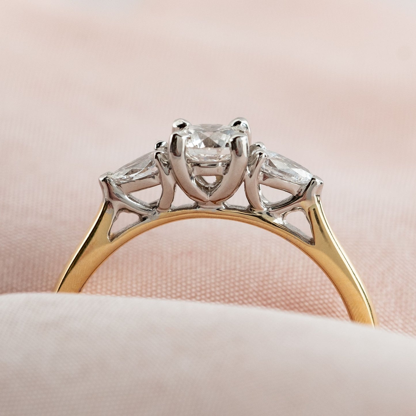 side profile of three stone diamond engagement ring