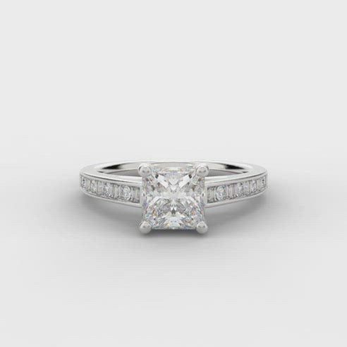 0.75ct Princess Cut Solitaire Diamond Engagement Ring with Diamond Set Shoulders  Centre Diamond Weight: 0.75ct  Centre Stone Cut: Princess Cut  Diamond Weight on Shoulders: 0.30ct  Diamond Cut on Shoulders: Round Brilliant & Baguette Cut  This ring is also available with Lab Grown Diamonds - contact us for further information.