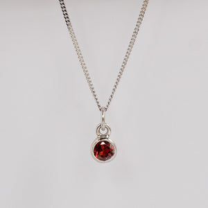 Garnet birthstone charm on a chain