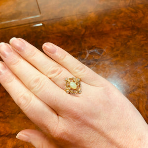 Vintage style opal ring shown on a hand