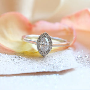 0.33ct Marquise Cut diamond in a Halo Setting  The centre stone is beautifully accented by a halo of round brilliant cut diamonds totalling 0.15ct.  This gives total diamond weight of 0.48ct