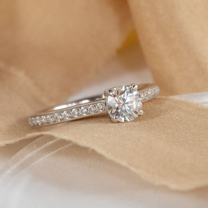 Solitaire diamond engagement ring with diamond accented shoulders