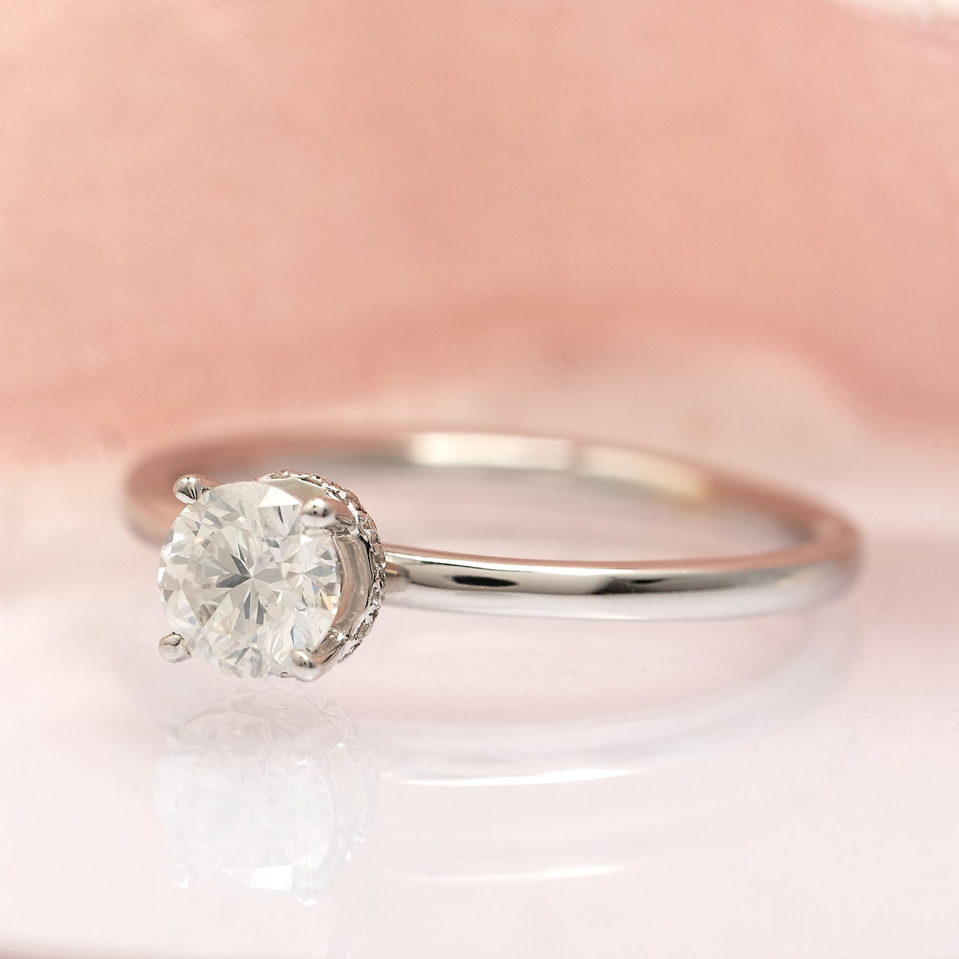 An 18ct white gold solitaire diamond ring with a hidden halo