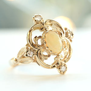 A vintage style opal and diamond gold ring